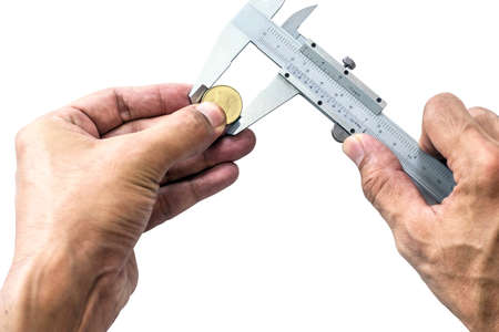 Closeup a man's hand is using Vernier to measure the size of a coin isolated on white background.の写真素材