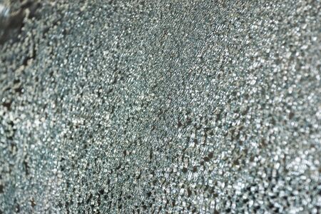 Closeup surface of the car glass cracks caused by an accident on the road leading to the insurance claim in the garage.の写真素材