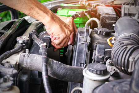Cars mechanic is checking the cooling fans of a car, the automotive industry and the garage concept.の写真素材
