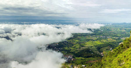 Panoramic view of the clouds covering the city taken from the highest point at the top of the mountain in Thailand.の写真素材