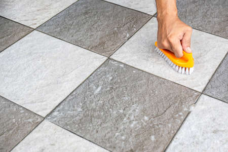 Men's hands are used to convert polishing cleaning on the tile floor.の写真素材