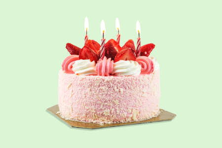 Close up of a birthday cake with candles on a pastel color background.の写真素材