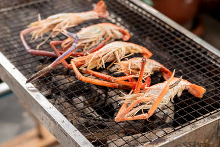 Closeup some river prawns grilled on the iron rack over the charcoal.の写真素材