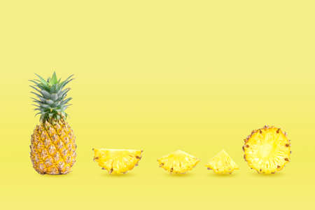 Collection of group pineapples and sliced isolated on yellow pastel colors background.の写真素材