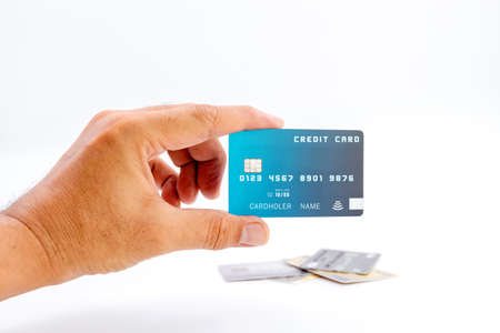 Human hand holding bank credit cards on white background.の写真素材