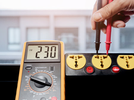 Measure the AC voltage of 230 Volts from the power outlet with a digital meter.の写真素材
