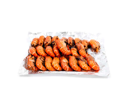 Arrange grilled river prawns on foil to deliver to customers ordering food online.の写真素材