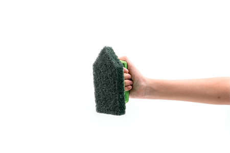 Close up human hand holding a green plastic scrubber isolated on white background.の写真素材
