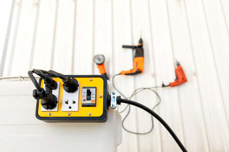 Close-up of yellow color trailer plug 4 sockets with breaker for use with hand tools.の写真素材