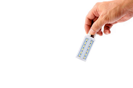Human hand holding LED light bulb isolated on white background.の写真素材