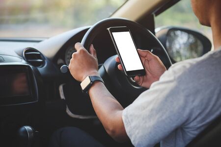 Cropped shot view of man hands holding smart phone with blank copy space screen for your text message or information content, female reading text message on cell telephone during in urban setting. の写真素材