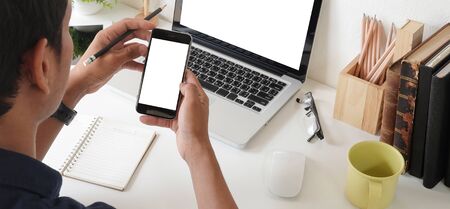 Cropped shot view of man hands holding smart phone with blank copy space screen for your text...