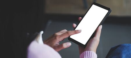Cropped shot view of man hands holding smart phone with blank copy space screen for your text...