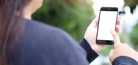 Cropped shot view of man hands holding smart phone with blank copy space screen for your text...