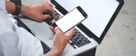 Cropped shot view of man hands holding smart phone with blank copy space screen for your text...