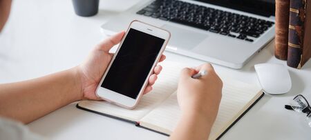 Cropped shot view of man hands holding smart phone with blank copy space screen for your text...