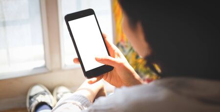 Cropped shot view of man hands holding smart phone with blank copy space screen for your text...
