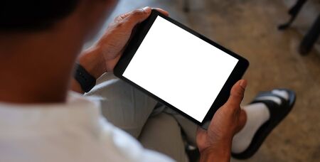 Cropped shot view of man hands holding smart phone with blank copy space screen for your text message or information content, female reading text message on cell telephone during in urban setting.の写真素材