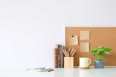 Contemporary workspace with stationery, supplies, decoration and copy space on white desk.の写真素材