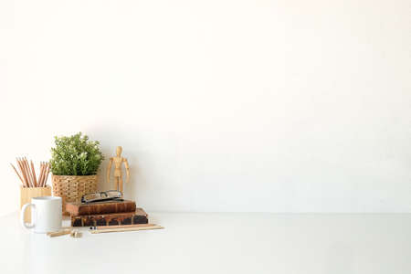 Mockup workspace desk and copy space books,plant and coffee on wood desk.の写真素材