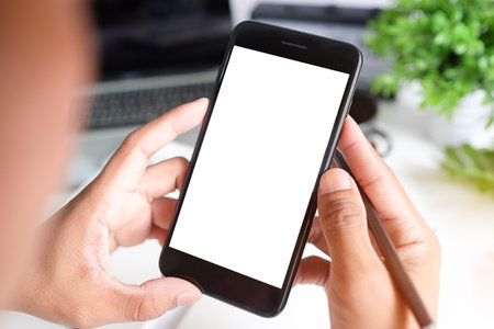 Cropped shot view of man hands holding smart phone with blank copy space screen for your text message or information content, female reading text message on cell telephone during in urban setting.の写真素材