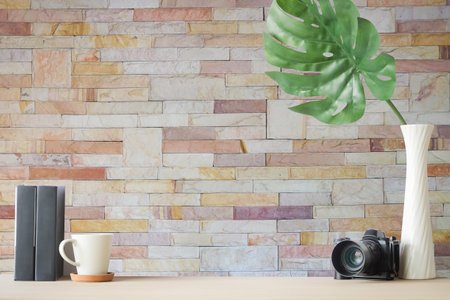 Copyspace of office equipment on white table with stone wall texture background.の写真素材