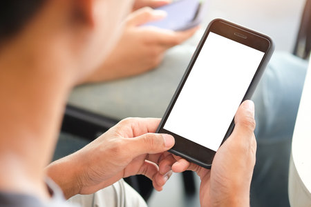 Close up of man using mobile smartphone at home, He searching or social networks.の写真素材