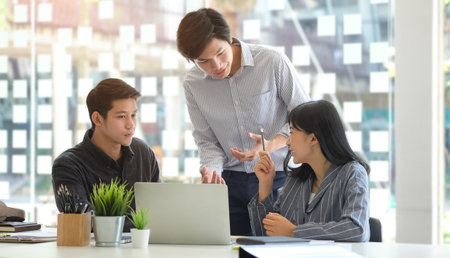 Business people discussing their project in meeting room at modern office.の写真素材