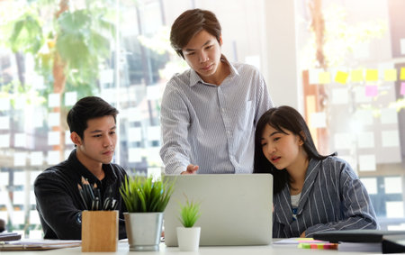 Business people discussing their project in meeting room at modern office.の写真素材