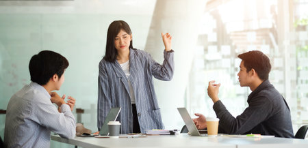 Business people discussing their project in meeting room at modern office.の写真素材