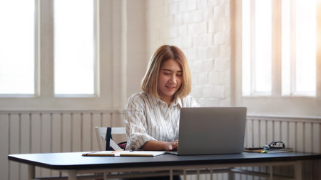 Portrait businesswoman using laptop for work on work space.の写真素材