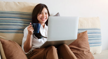 Business working in home living room enjoying sunny morning on the day with documents and laptop people Consulting and business planning.の写真素材