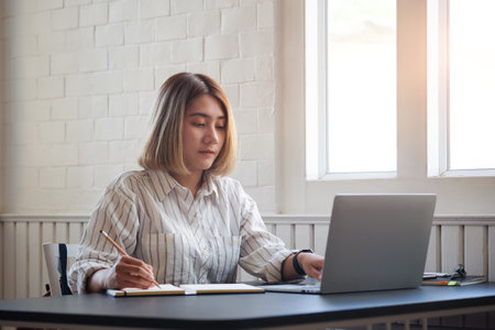 Portrait businesswoman using laptop for work on work space.の写真素材