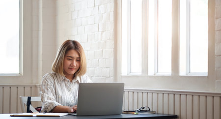 Portrait businesswoman using laptop for work on work space.の写真素材