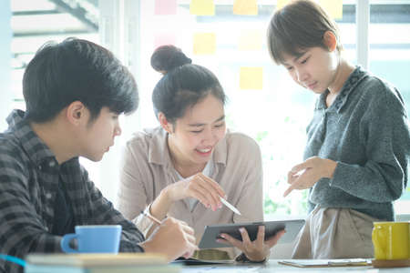 Group of young designer at meeting table for discussing the new successful startup project.の写真素材