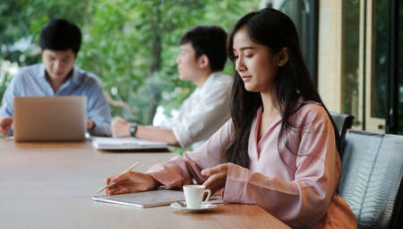 Business people discussing their project in meeting room at modern office.の写真素材