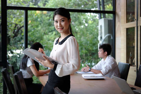 Portrait of successful Asian businesswoman busy working in meeting room.の写真素材