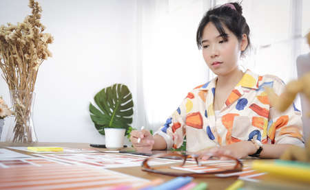 Concept business man working and people happy businessman or creative female office worker with computers writing to notebook with documents and laptop.の写真素材