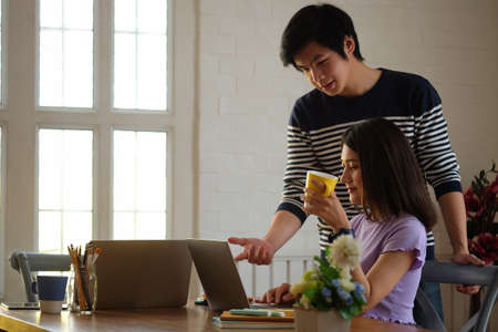 Two young designer working with computer laptop at creative workplace.の写真素材