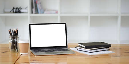 Office desk Workspace stuff with notepad, laptop and coffee cup mouse notepad shot.の写真素材