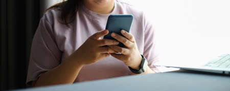 Cropped shot view of man hands holding smart phone with blank copy space screen for your text...