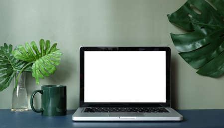 Modern workspace with computer with blank screen and equipment on white table.Blank screen for your...