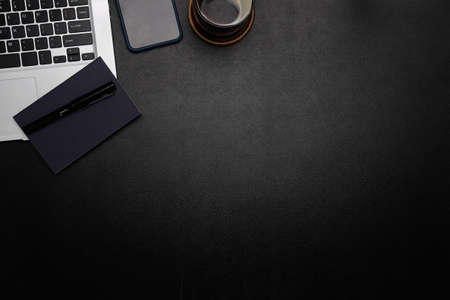 Top view office stuff with notepad, laptop and coffee cup mouse notepad shot.blank screen mobile phone and supplies on white desk workspace and copy space.の写真素材