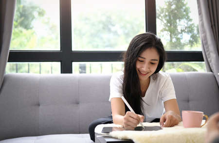 Startup small business owner working on digital tablet and prepare package box for customers.
