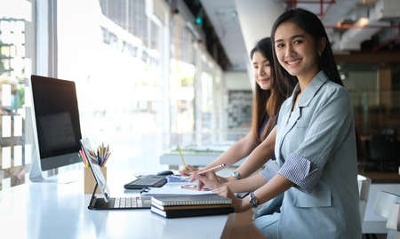 A businesswoman working on new project with laptop computer in modern office.の写真素材