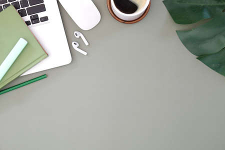 Top view of a graphic designer or photographer workspace with digital tablet, coffee cup, and...