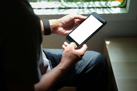 Close up view of business holding mobile phone with blank screen.の写真素材