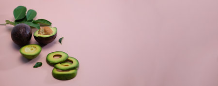 Fresh whole and sliced avocado isolated on pink background.の写真素材