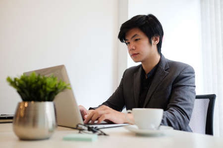 Businessman concentrate working with laptop in office.の写真素材