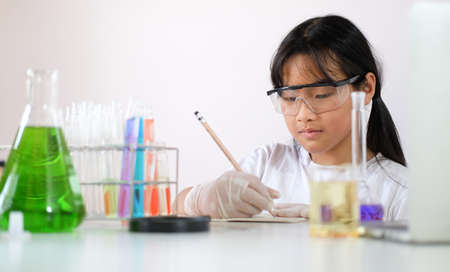 Asian school girl experimenting with chemicals at laboratory.の写真素材